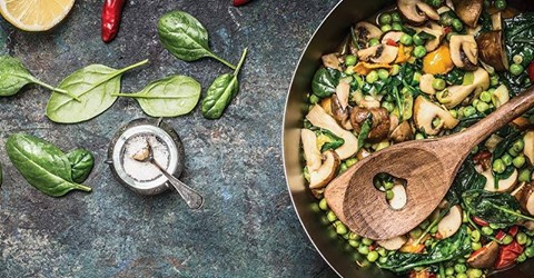 A cooking pot with vegetables in it