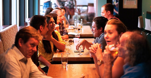 A group of people sitting a tables in a cafe or restaurant
