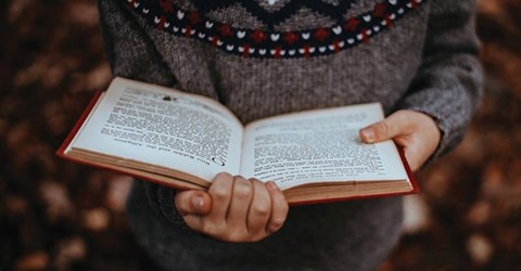 An extreme close up of a child reading a book. 